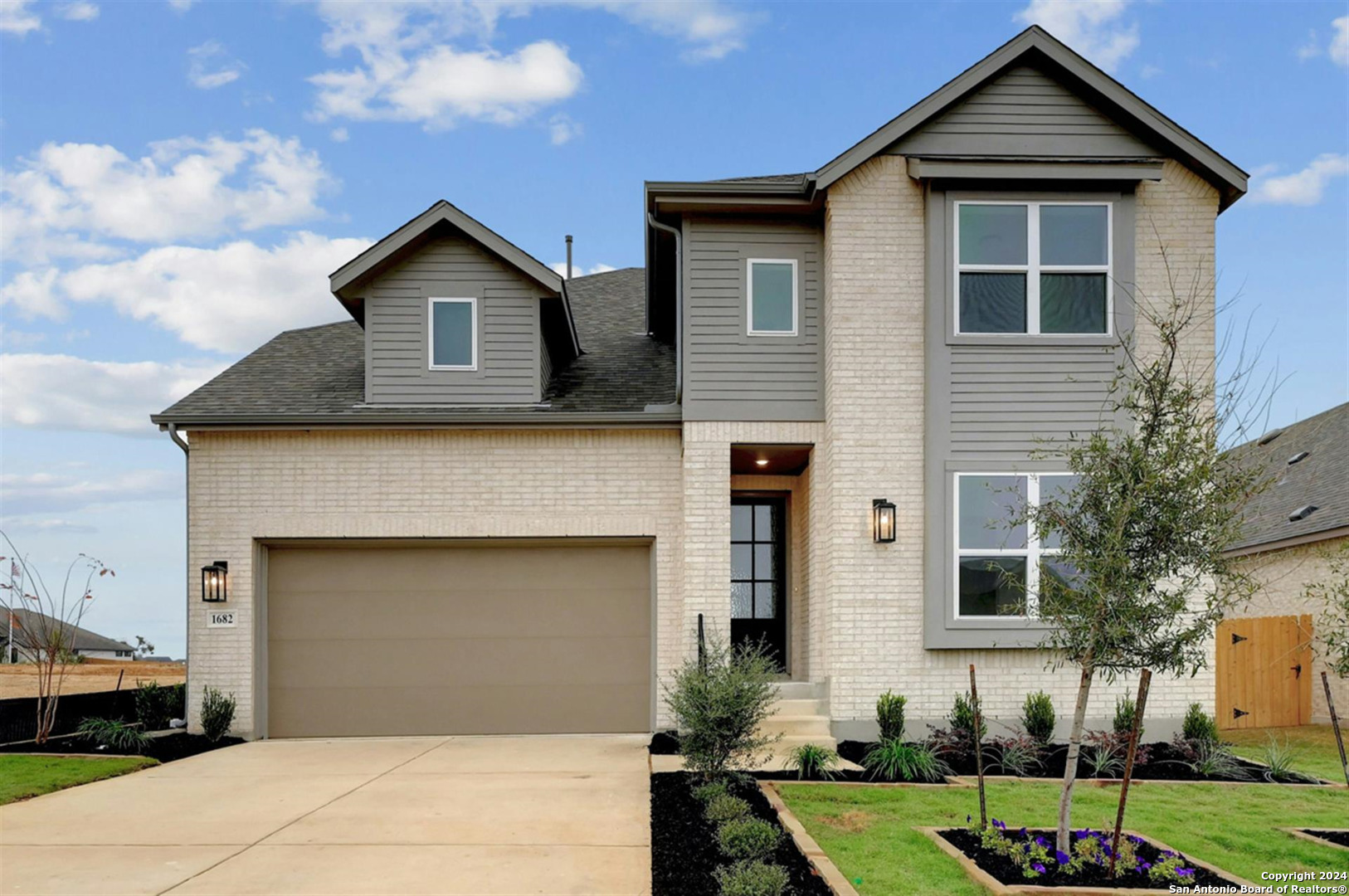 a front view of a house with a yard and garage