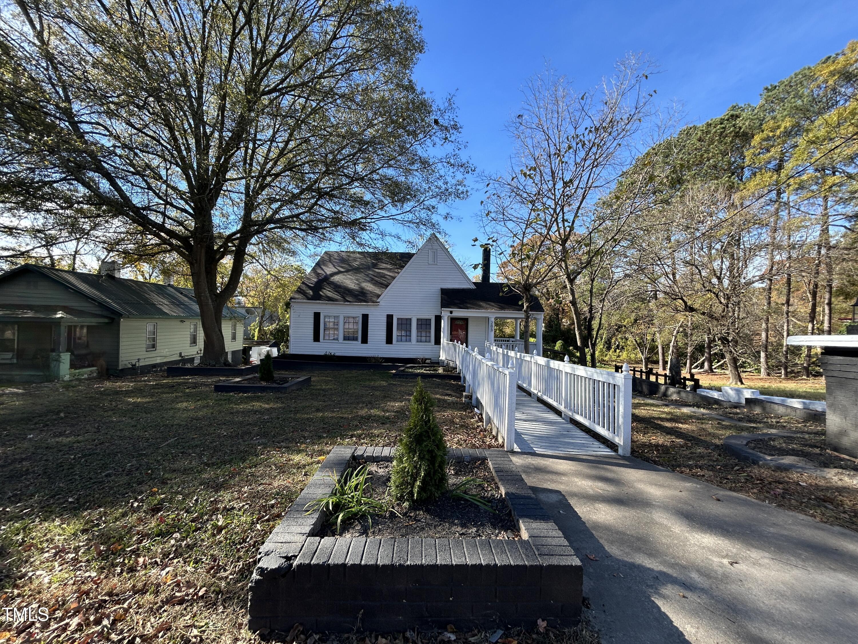 a view of a house with a yard covered with snow in the background