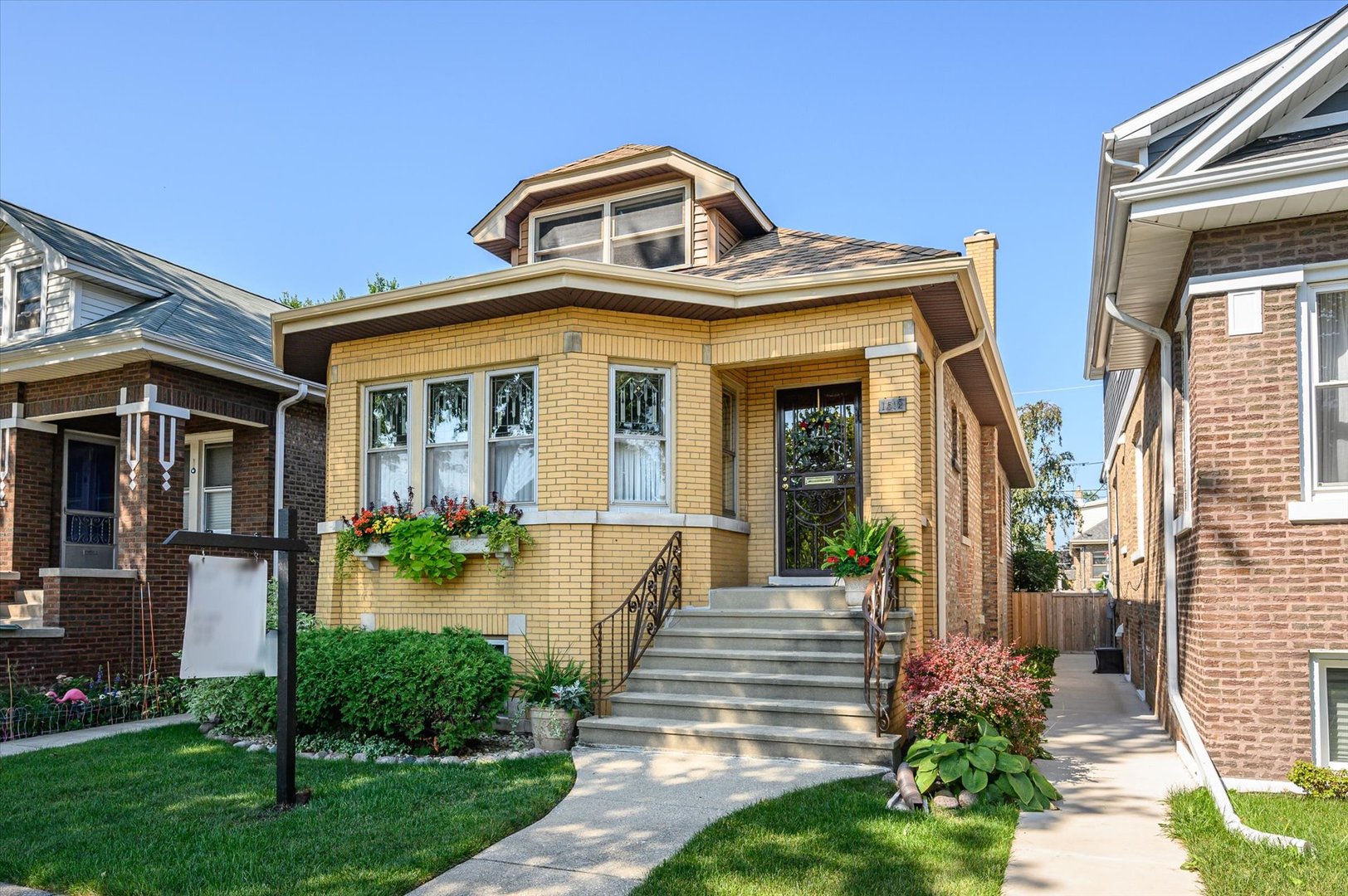 a front view of a house with garden