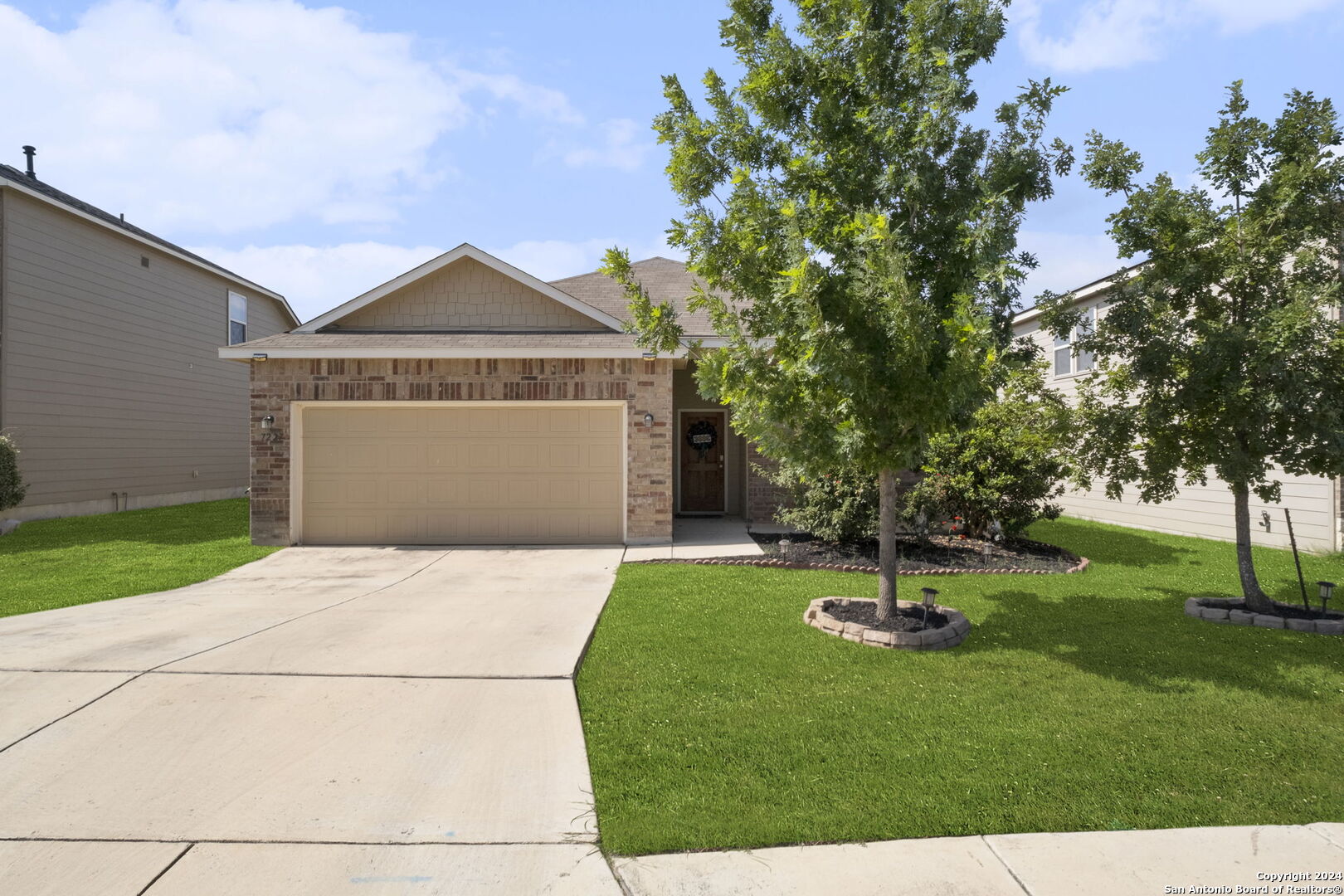 a front view of a house with garden