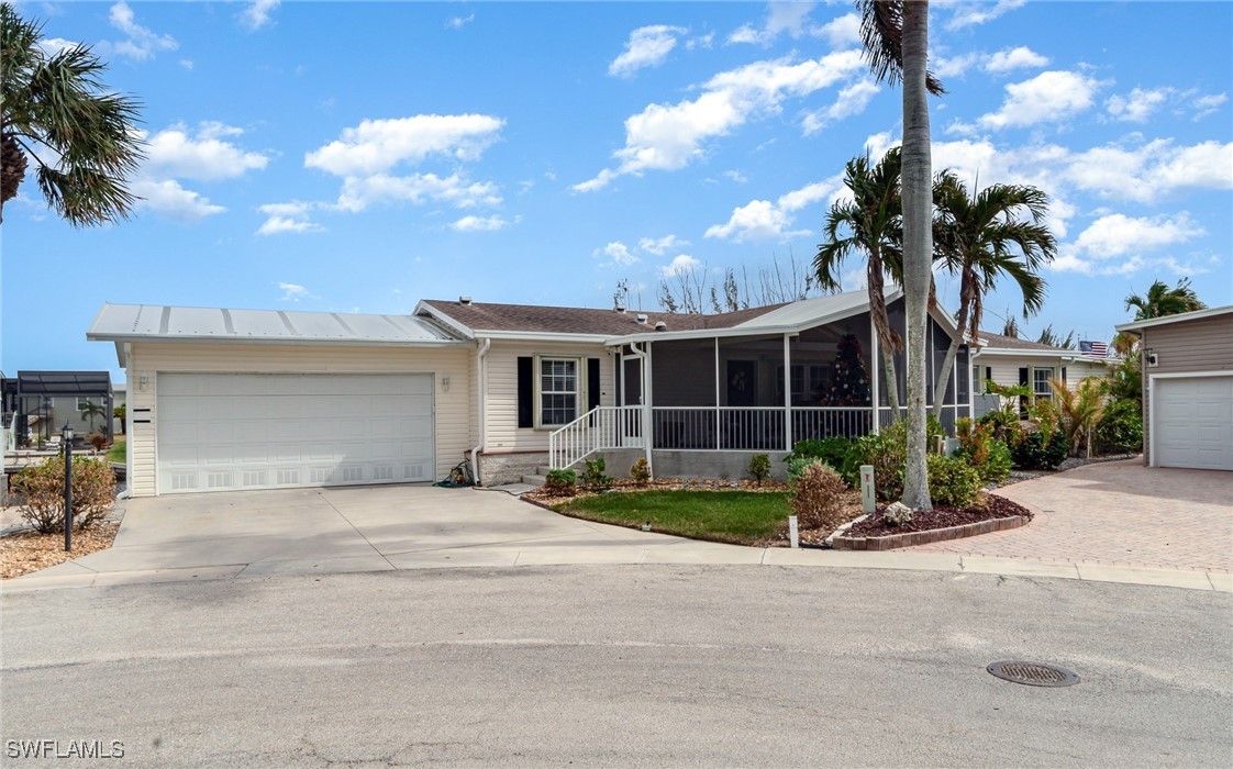 a front view of a house with garden and parking