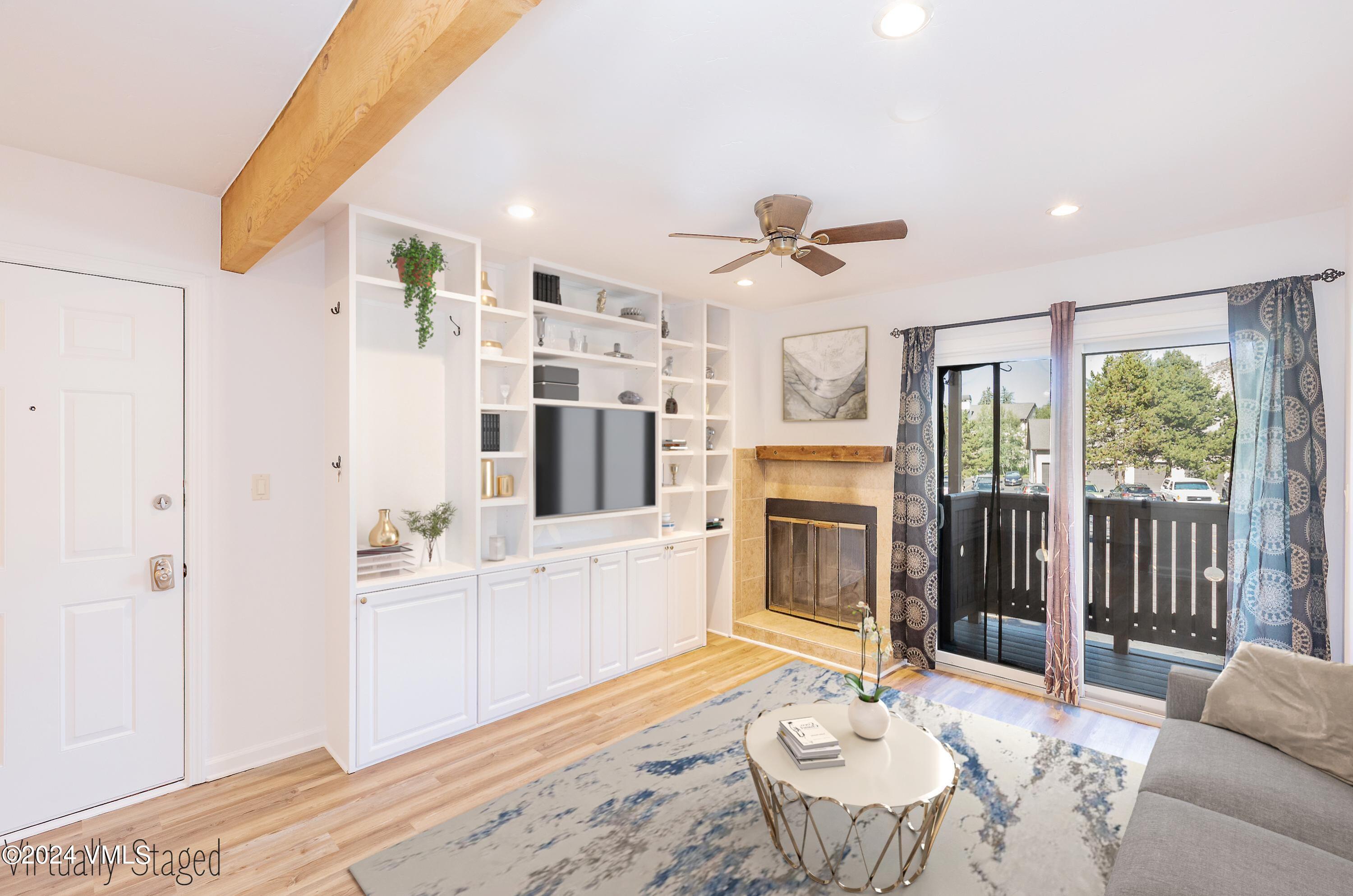 a living room with furniture a fireplace and a flat screen tv