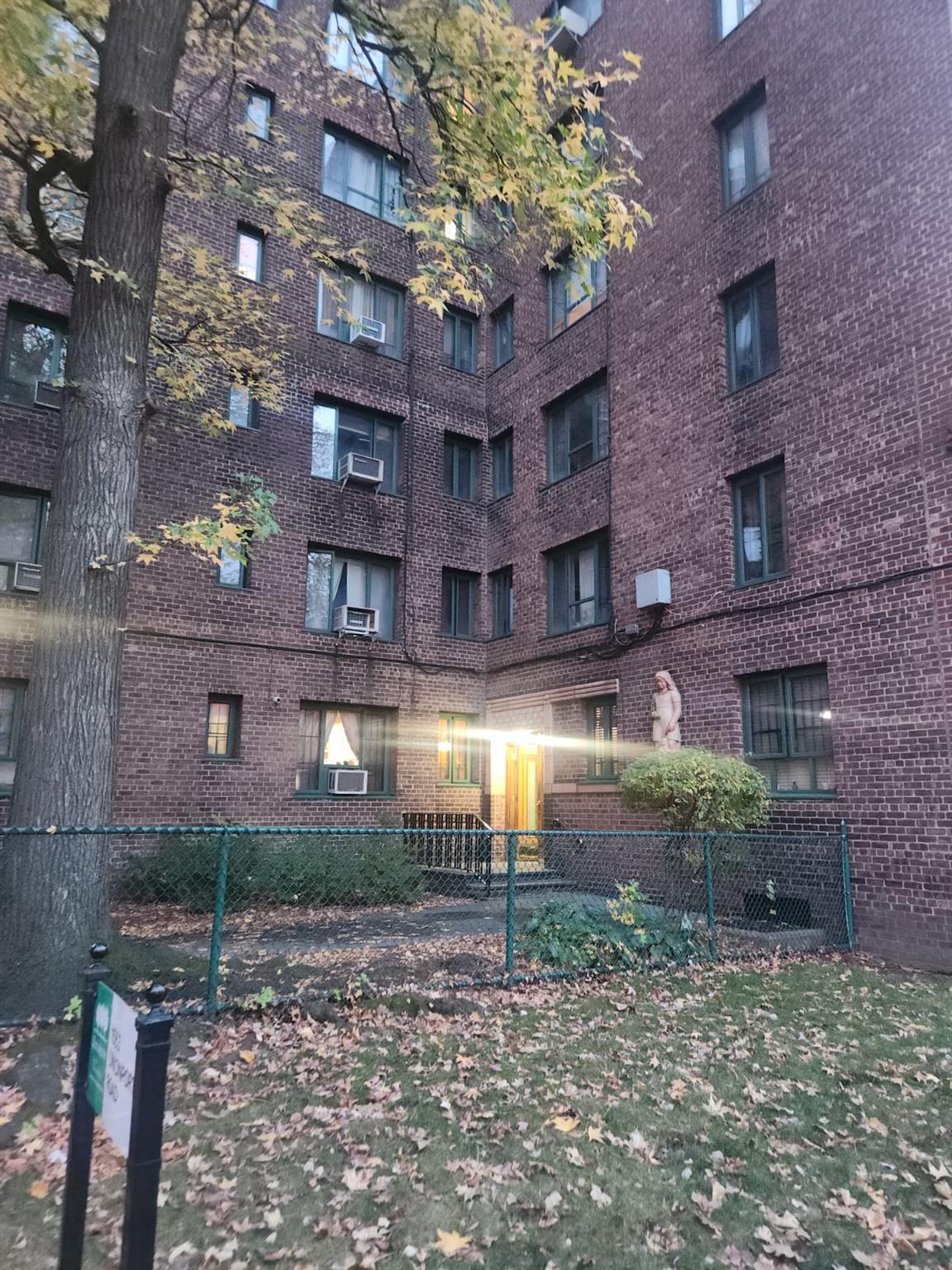 a view of a brick building next to a yard