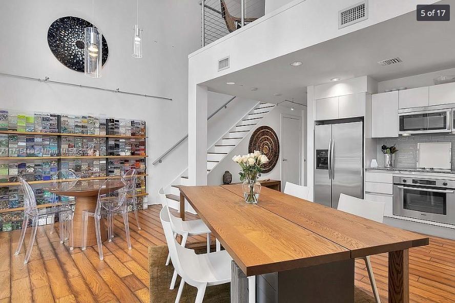 a large kitchen with a table and chairs