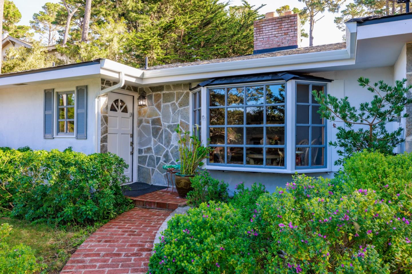 a front view of a house with garden