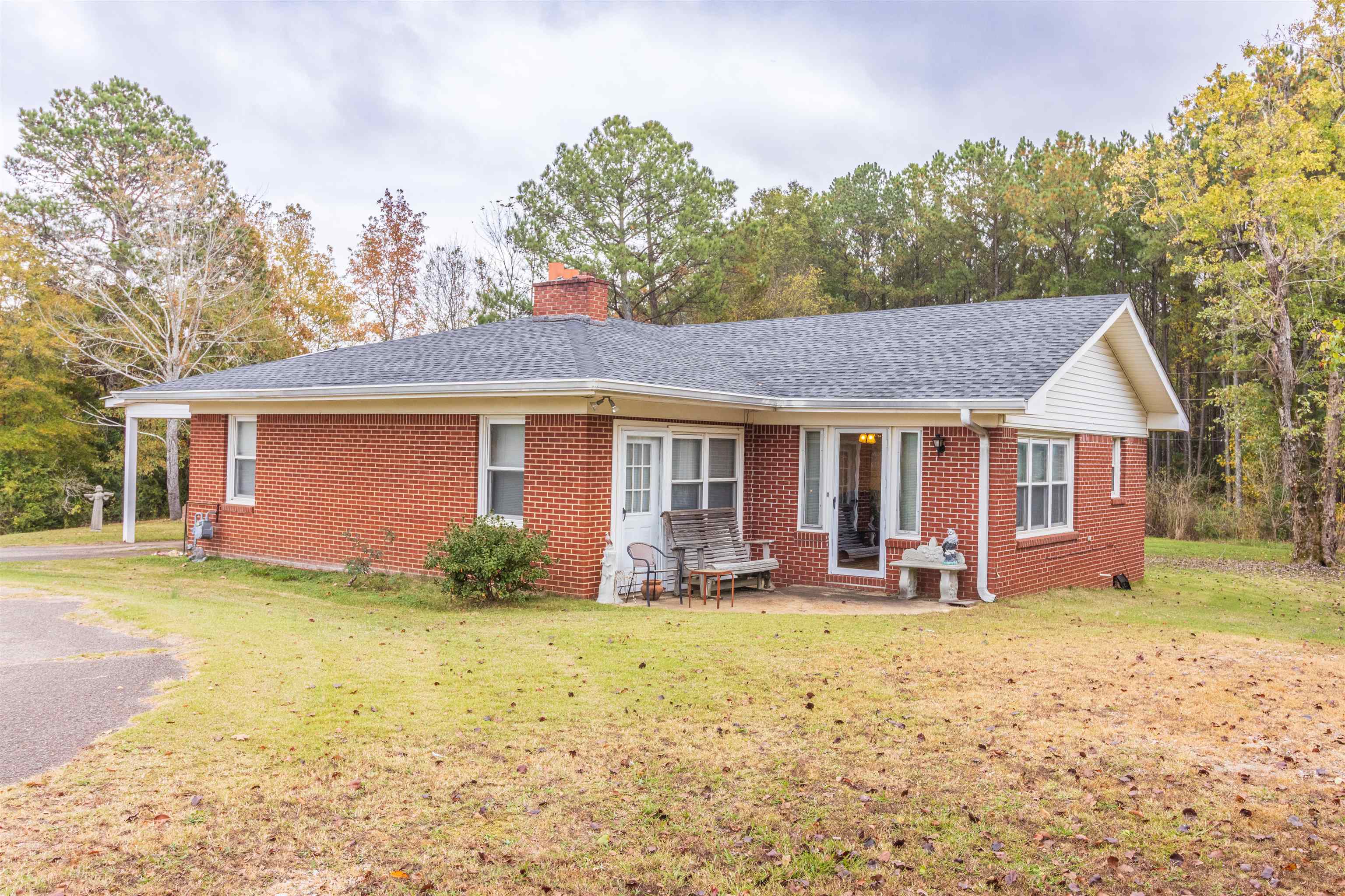 a front view of a house with yard and seating space