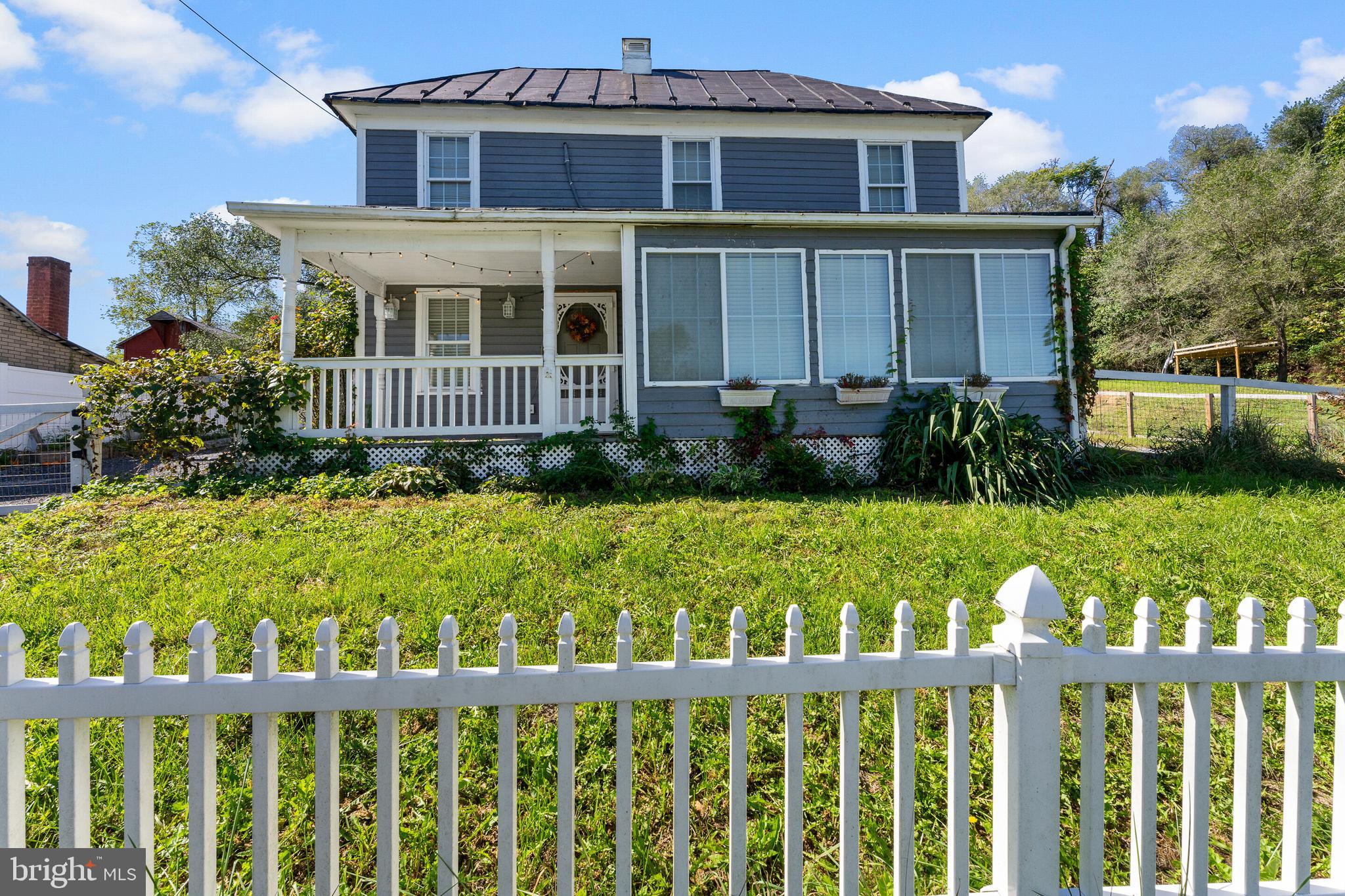 a view of a house with wooden fence