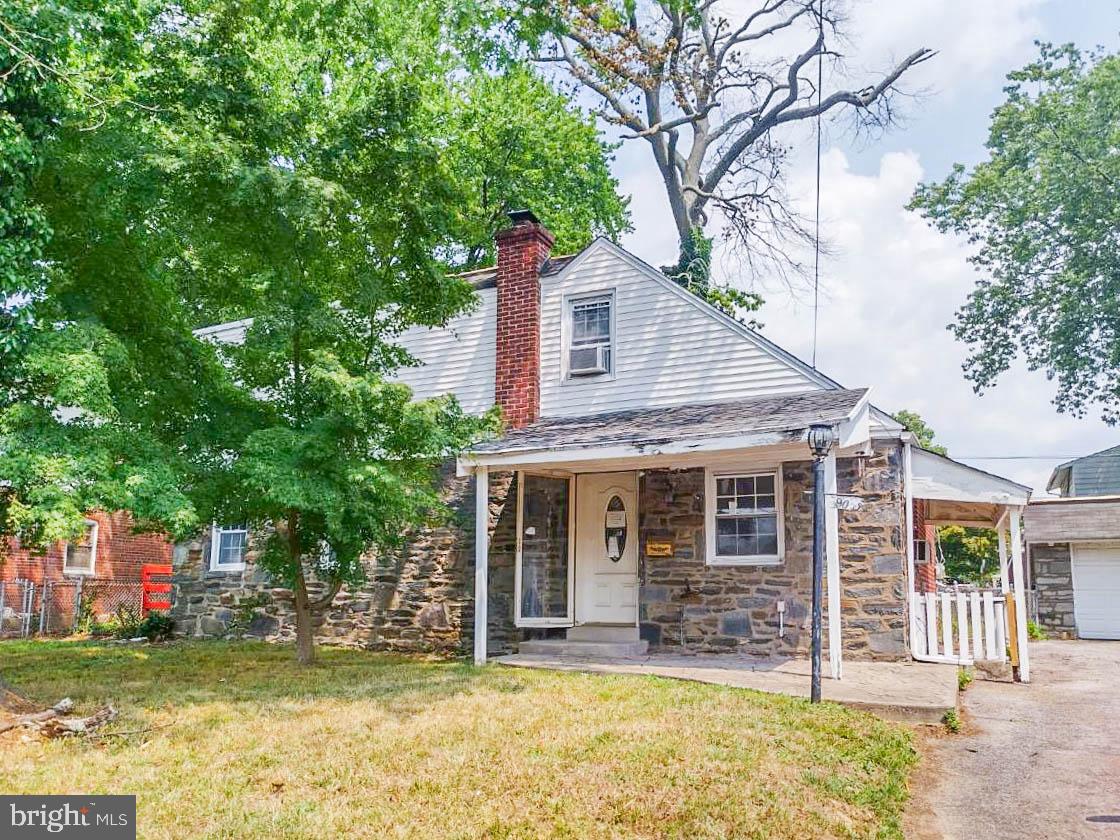 a view of a house with a patio and a yard