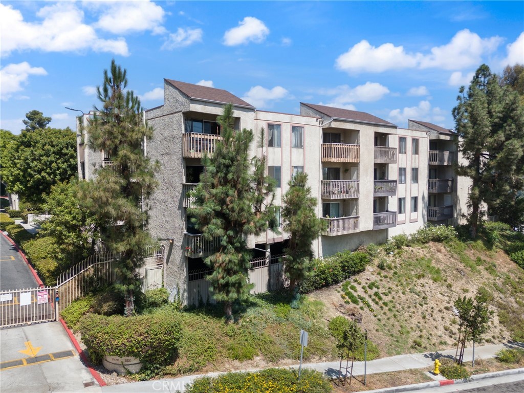 a front view of a residential apartment building with a yard