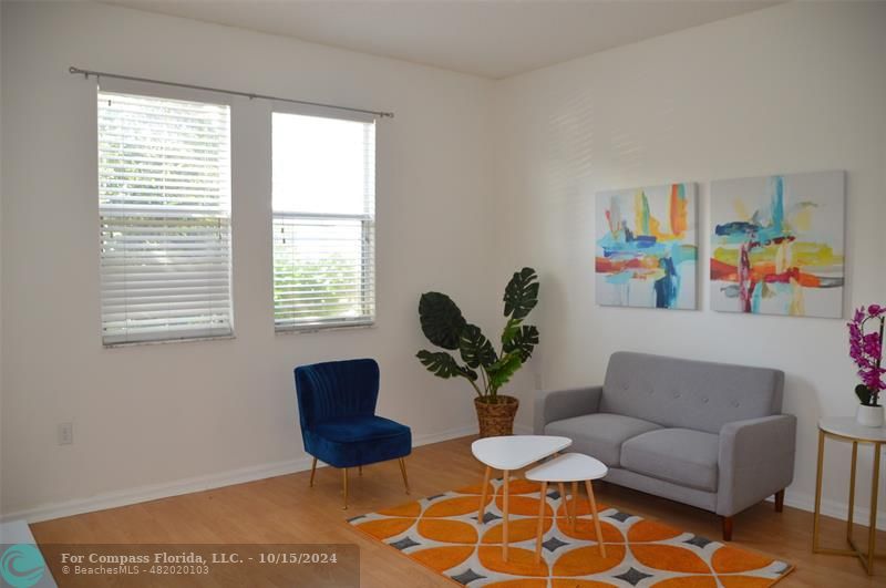 a living room with furniture and a potted plant