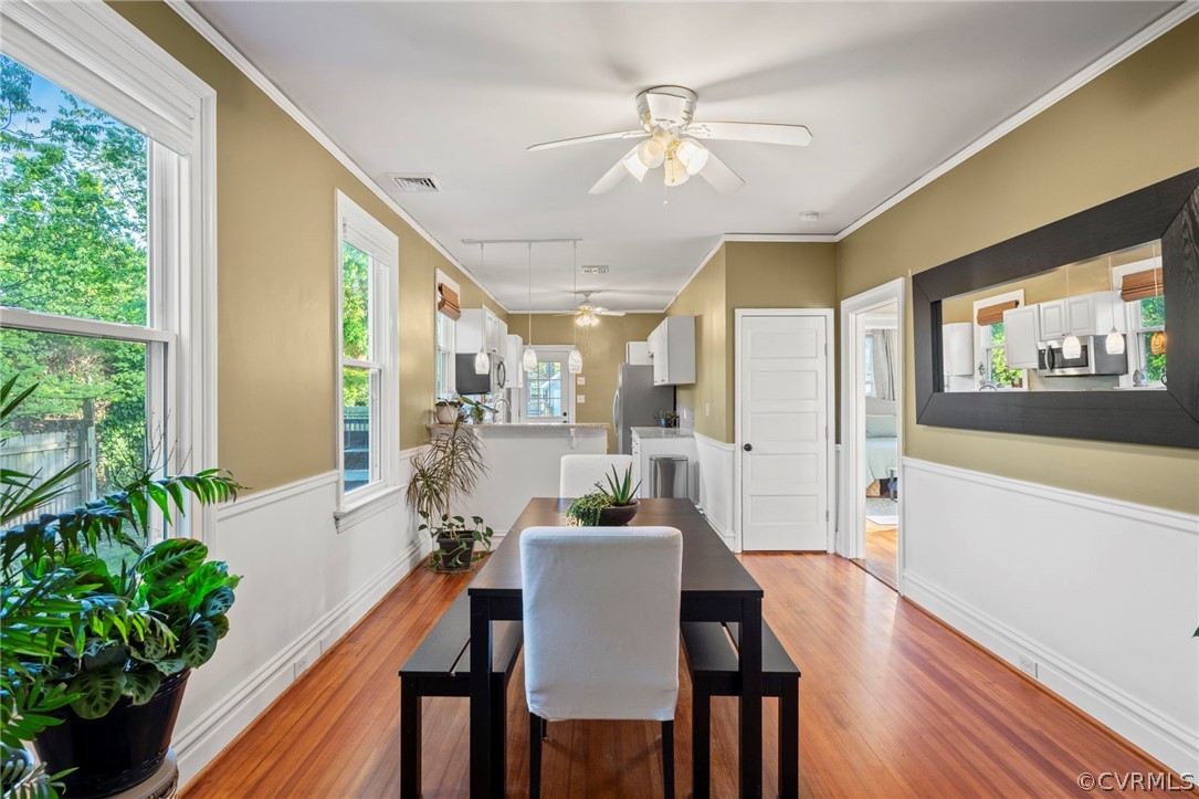 a view of a dining room with furniture window and wooden floor