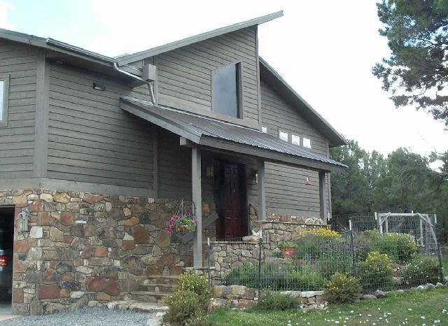 a front view of a house with plants