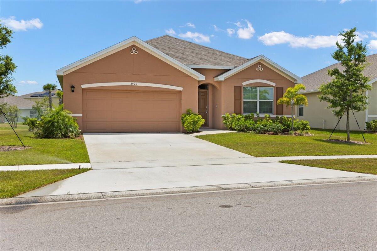 a front view of a house with a yard and garage