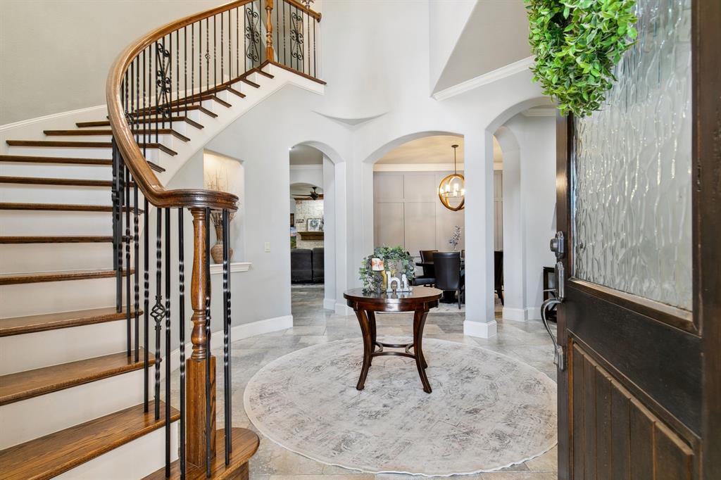 a view of a hallway to a livingroom with furniture and staircase