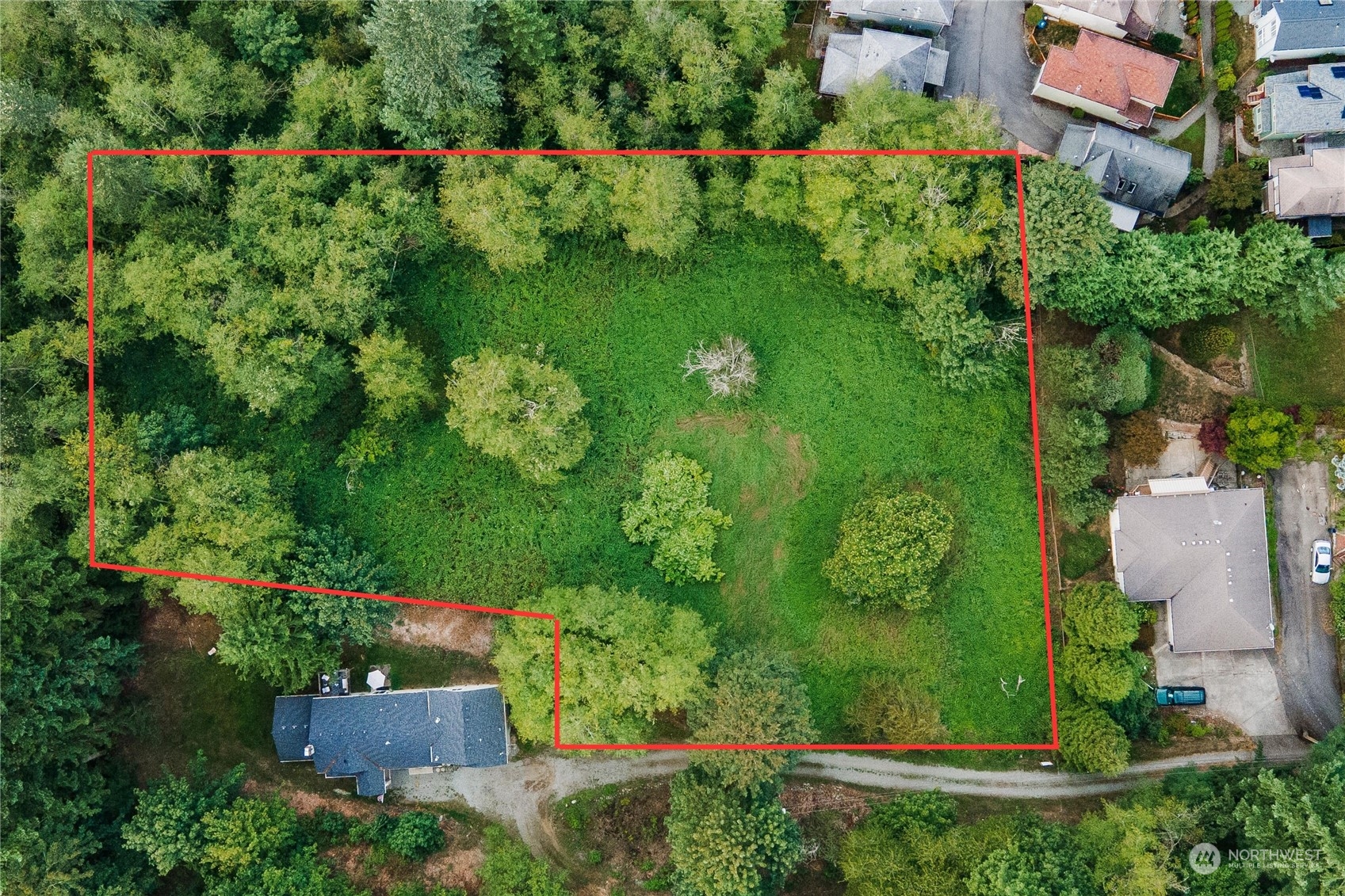 an aerial view of a house with a yard