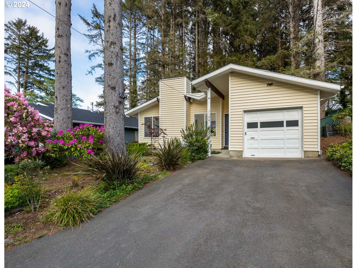 a view of a house with a yard and garage