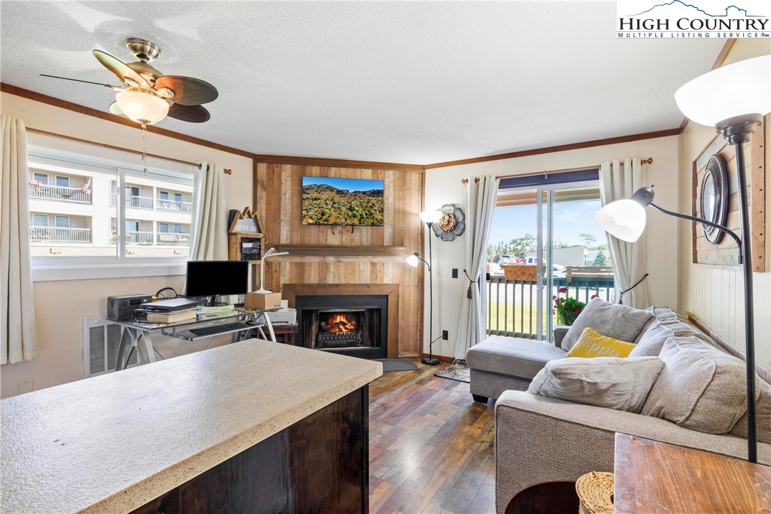 a living room with furniture a fireplace and a flat screen tv