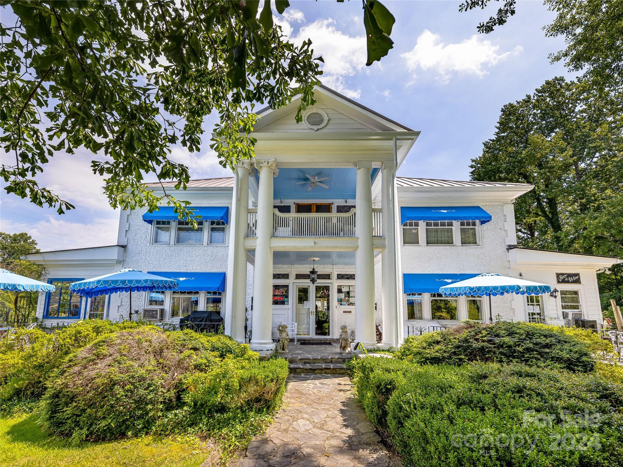 front view of a building with a garden