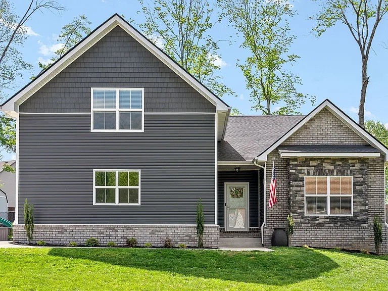 a front view of a house with a yard