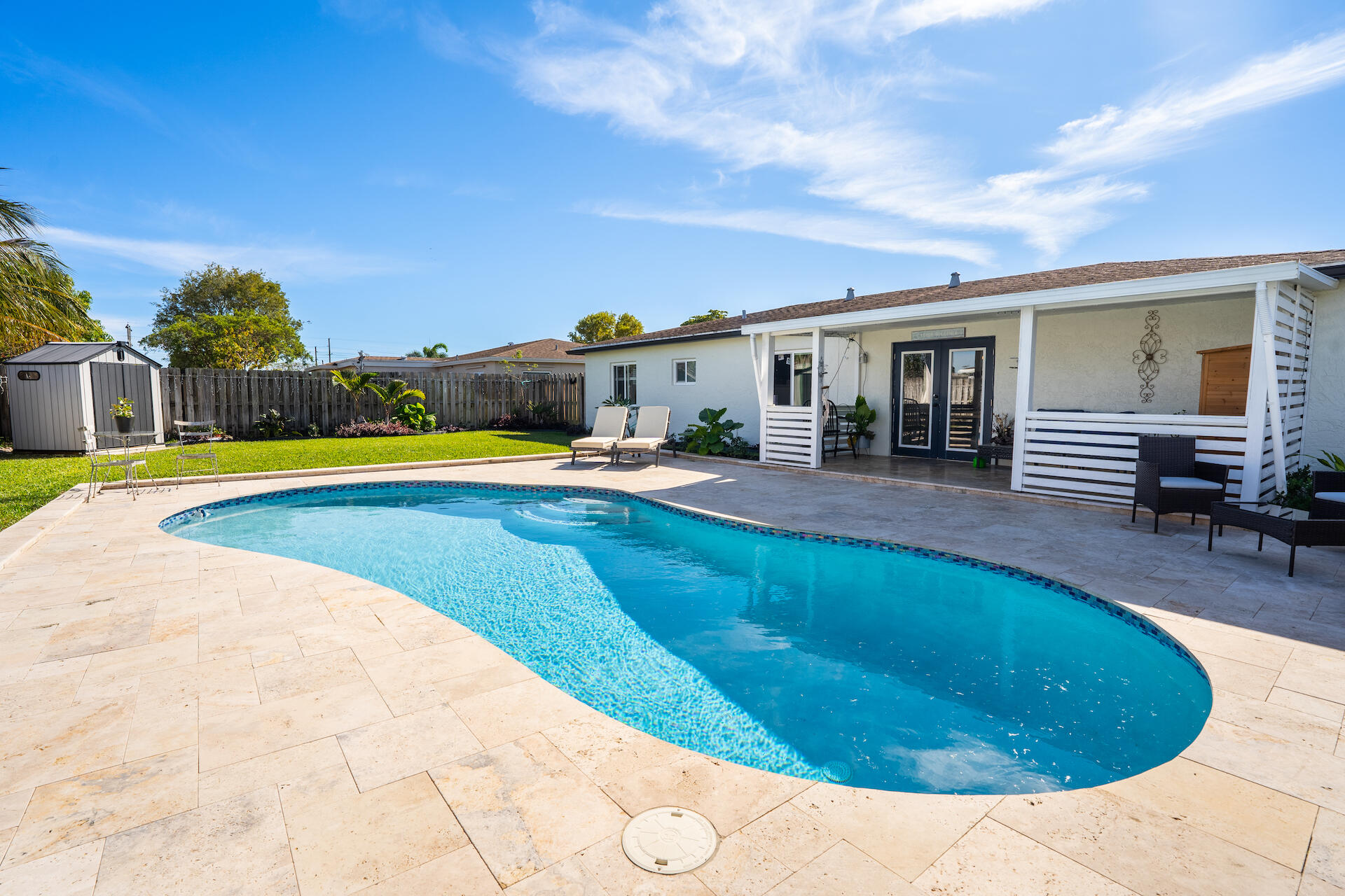 a swimming pool with outdoor seating and yard