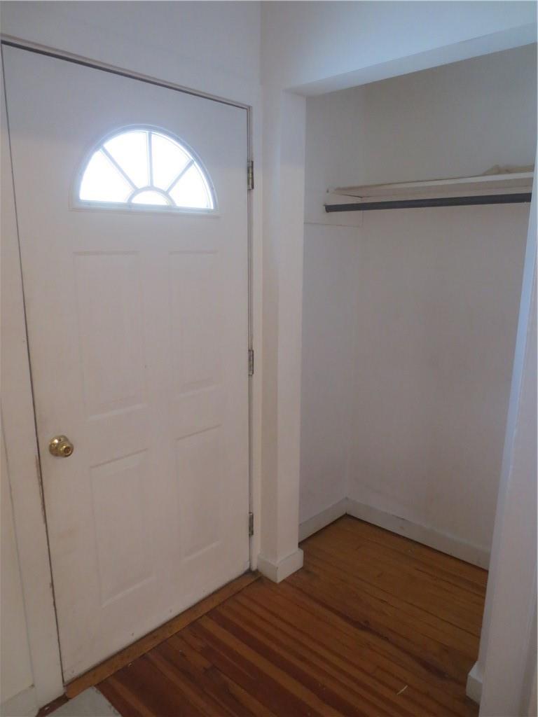 Entrance foyer with hardwood / wood-style floors