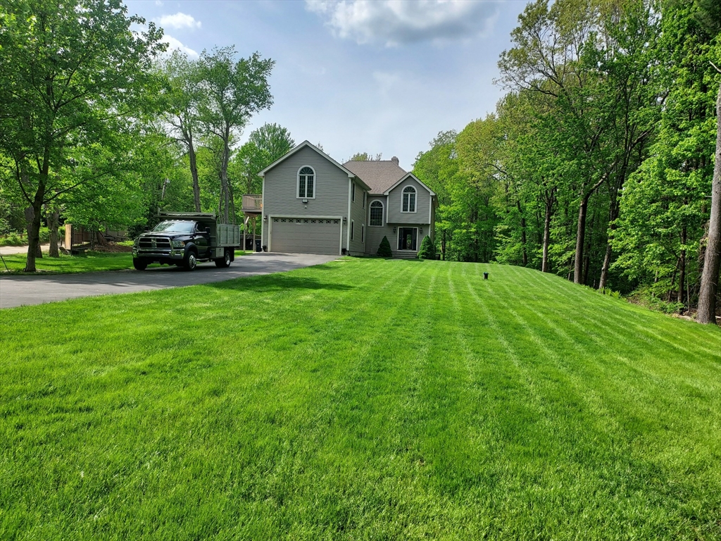 a front view of a house with yard