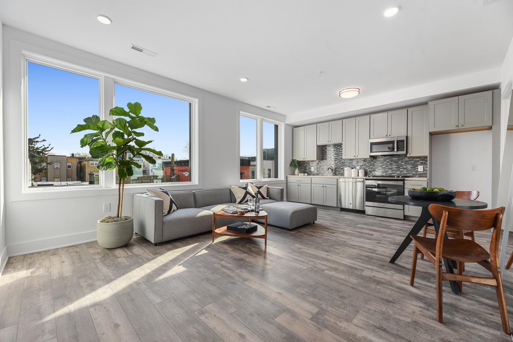 a living room with furniture and a potted plant