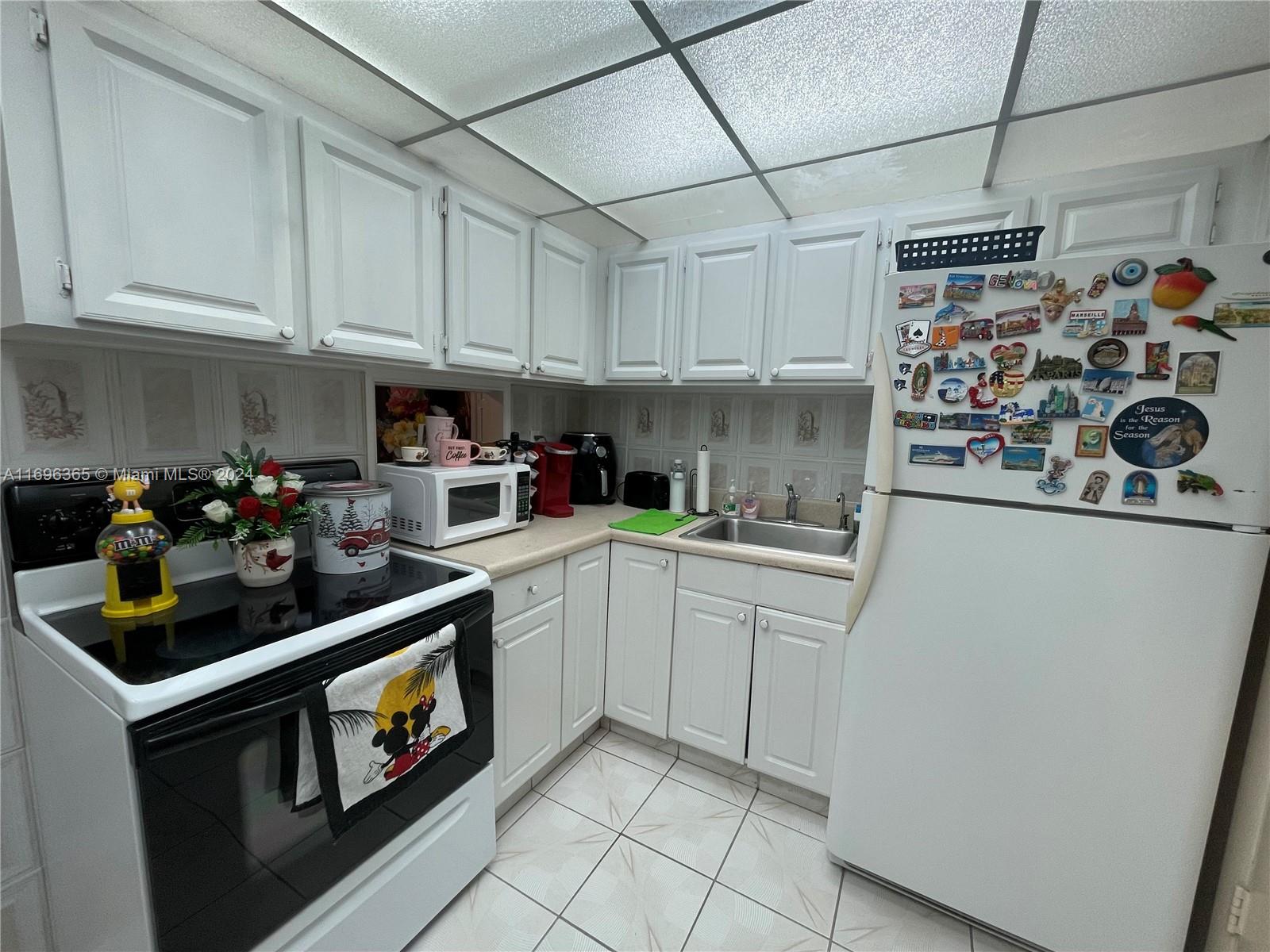 a kitchen with refrigerator and cabinets