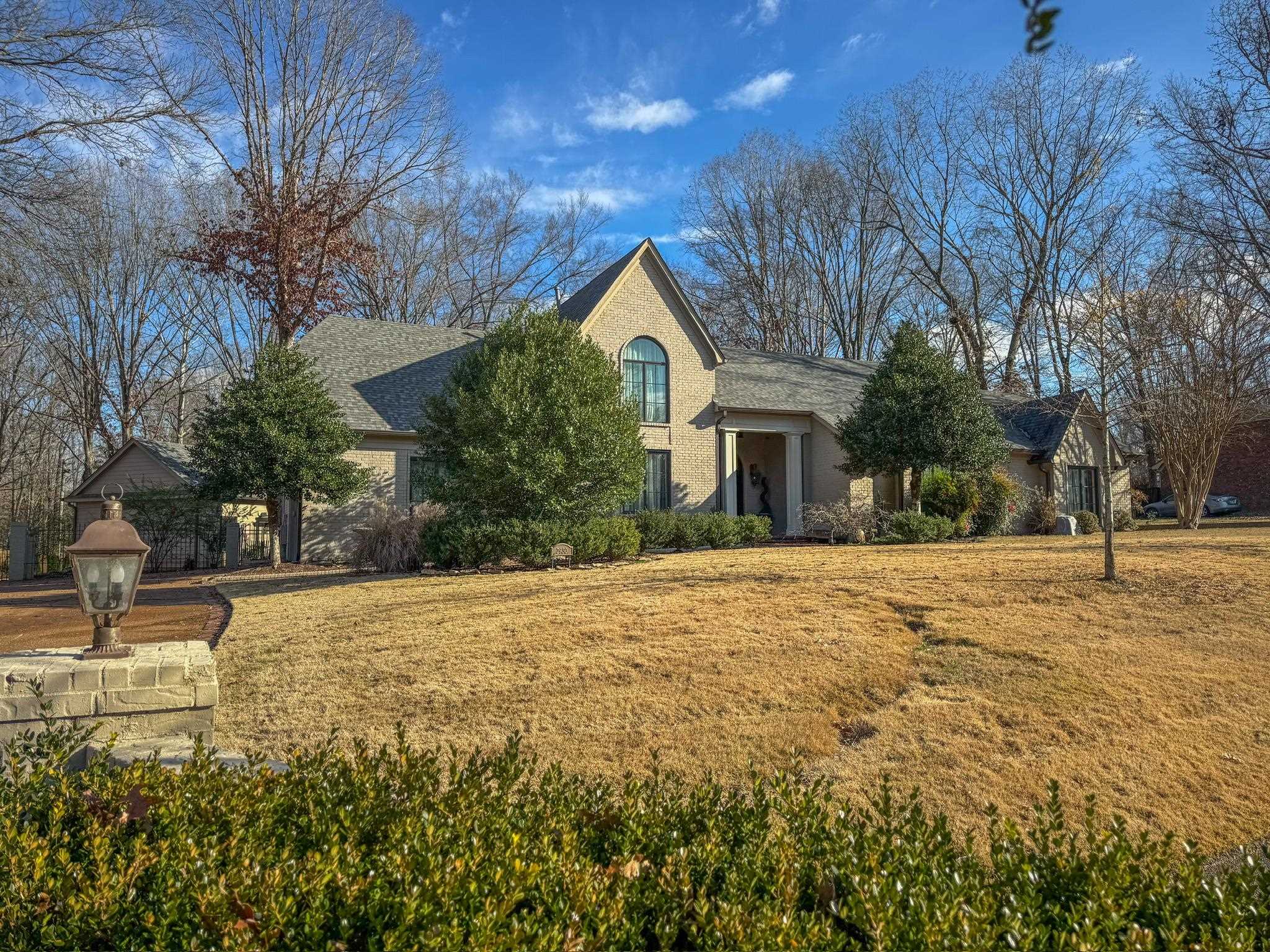 a house with yard and trees in front of it