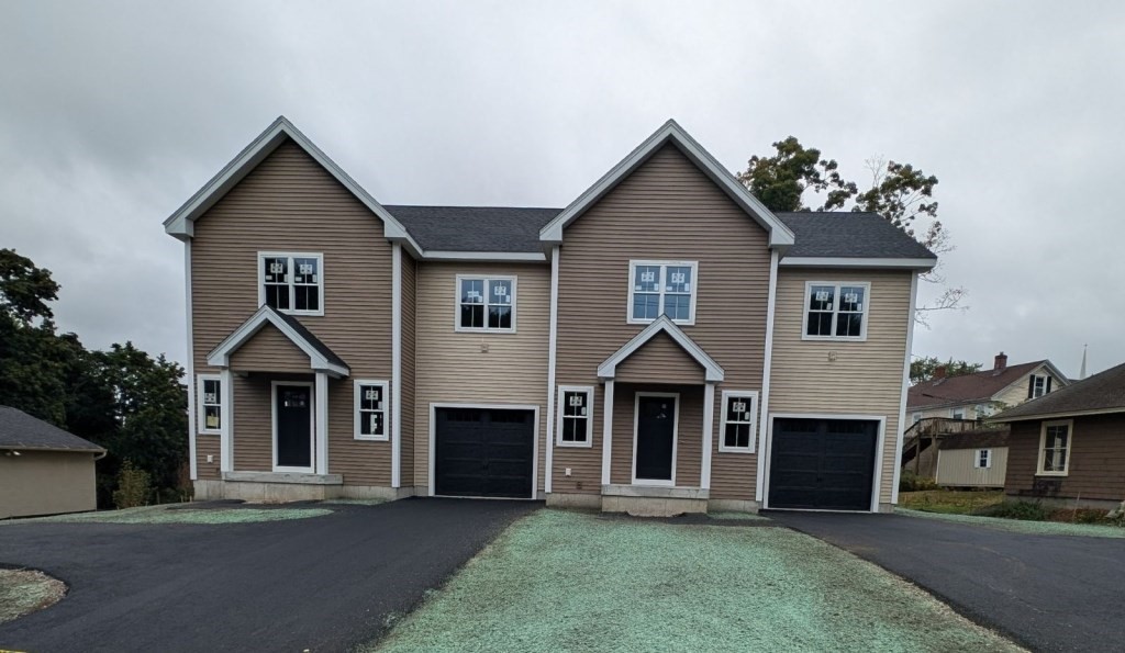 a front view of a house with yard