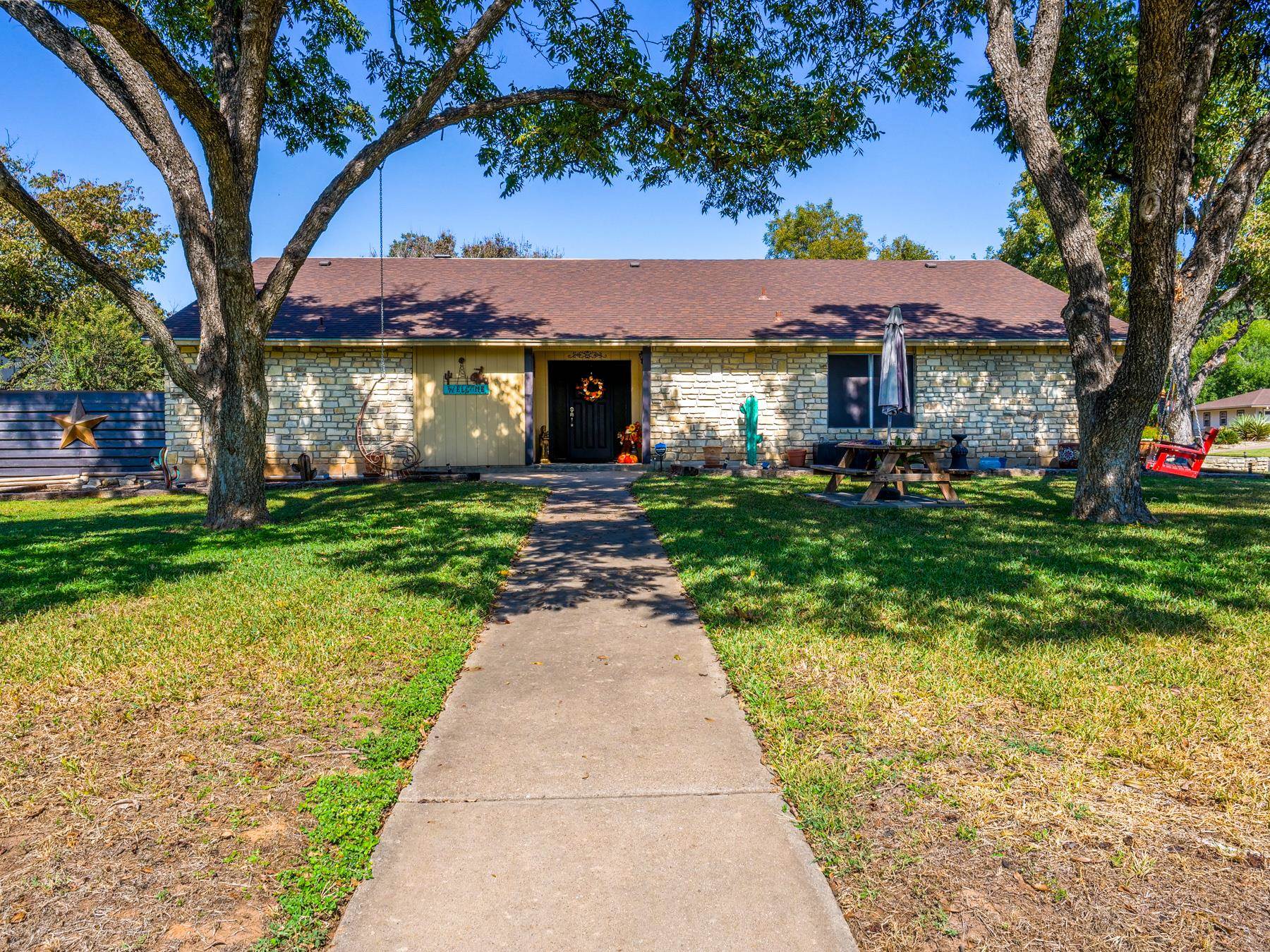 a front view of a house with a garden