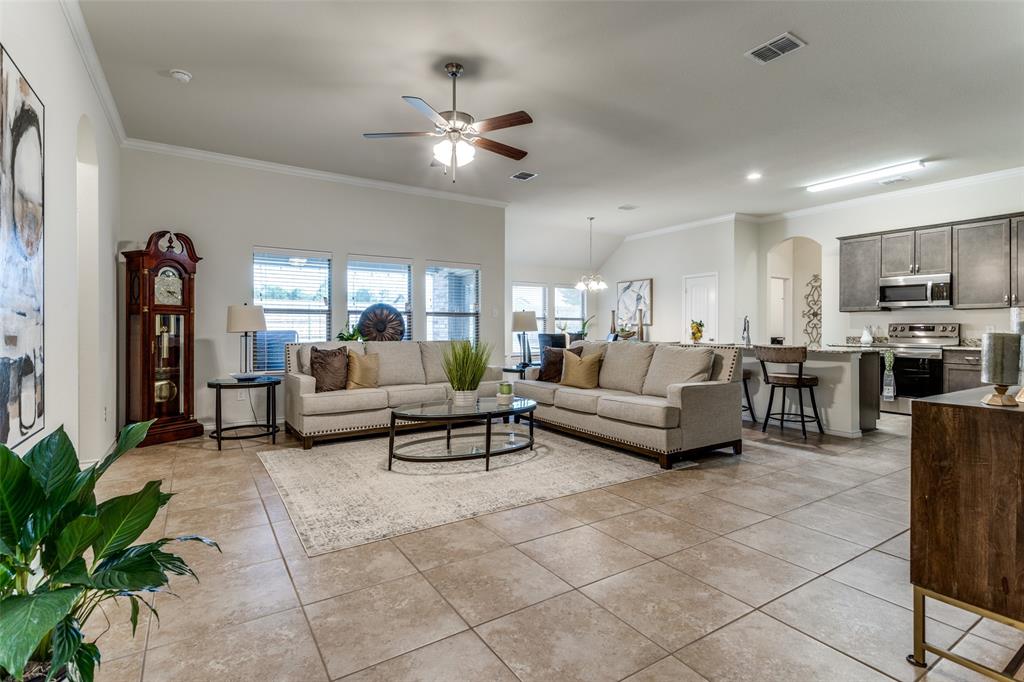 a living room with furniture and kitchen view