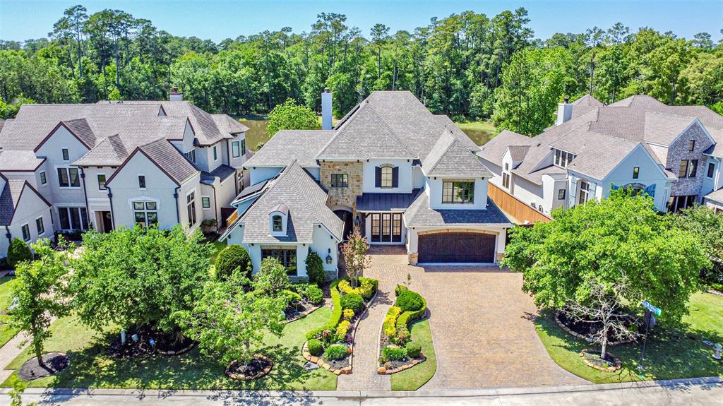 an aerial view of a house with a yard and garden