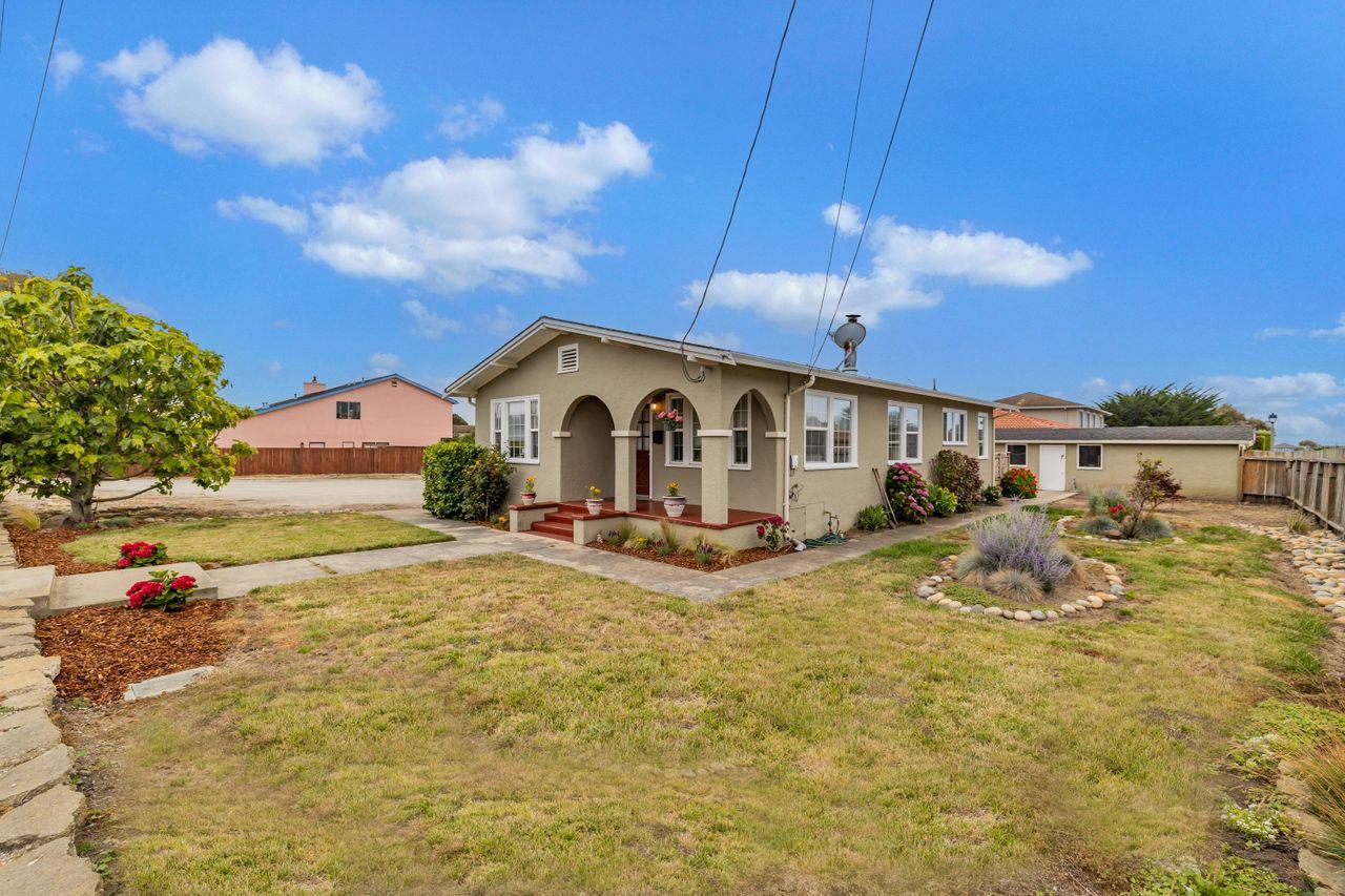 a view of a house with backyard and sitting area