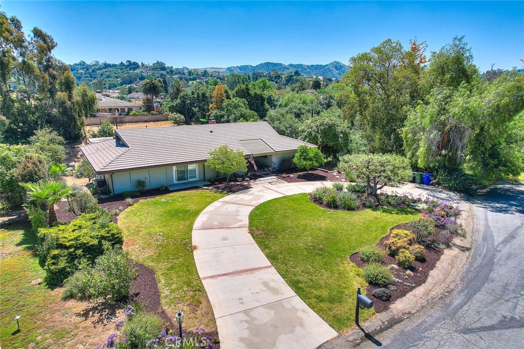 an aerial view of a house with garden space and street view