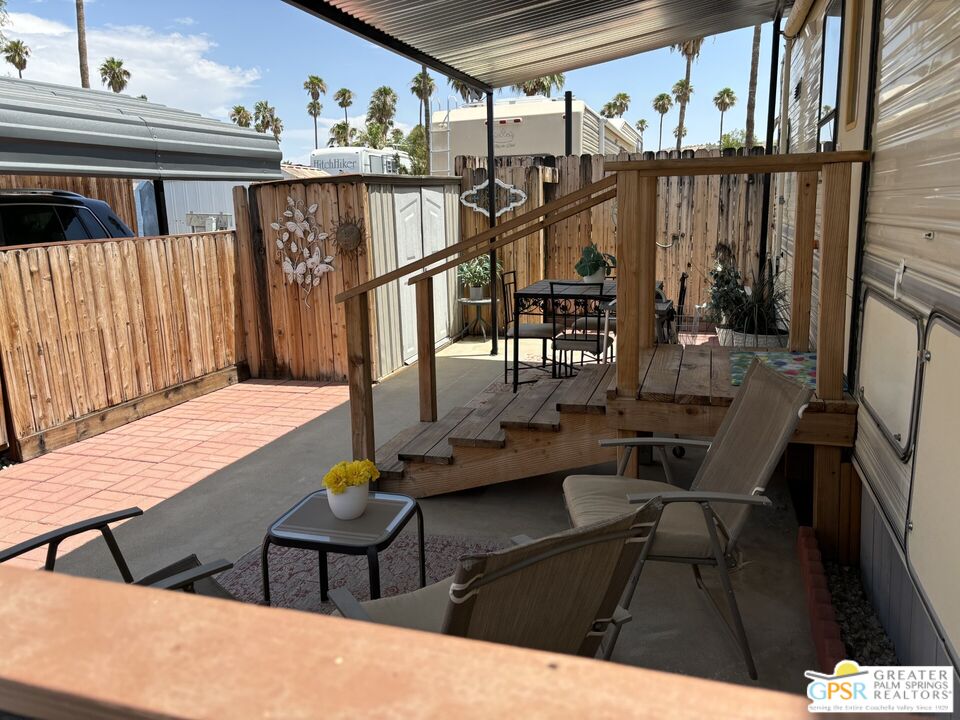 a balcony with table and chairs