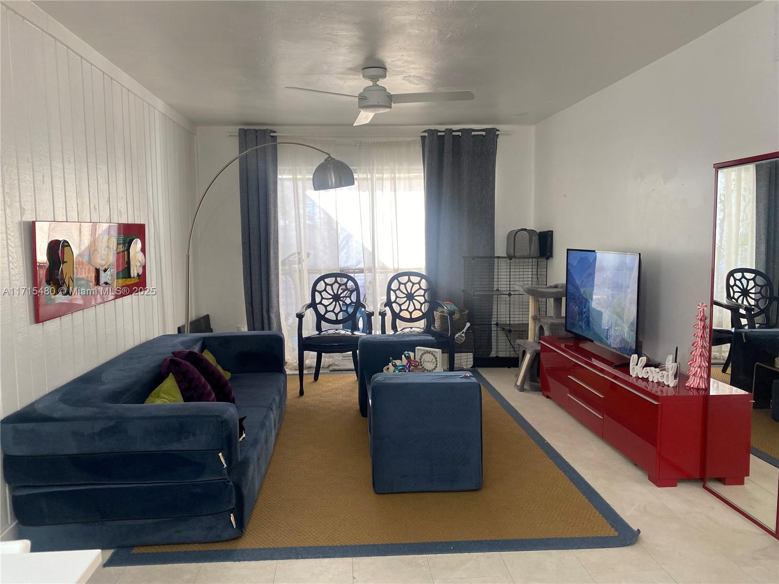 a living room with furniture a rug and a flat screen tv