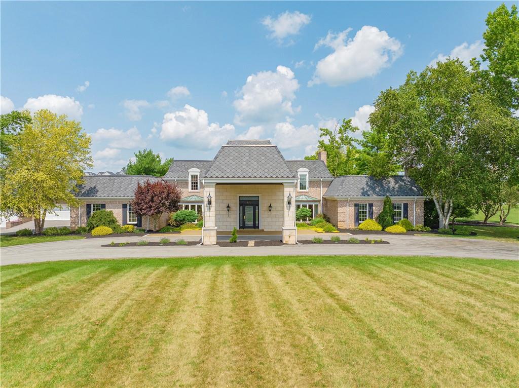 a view of a house with a swimming pool and a large tree