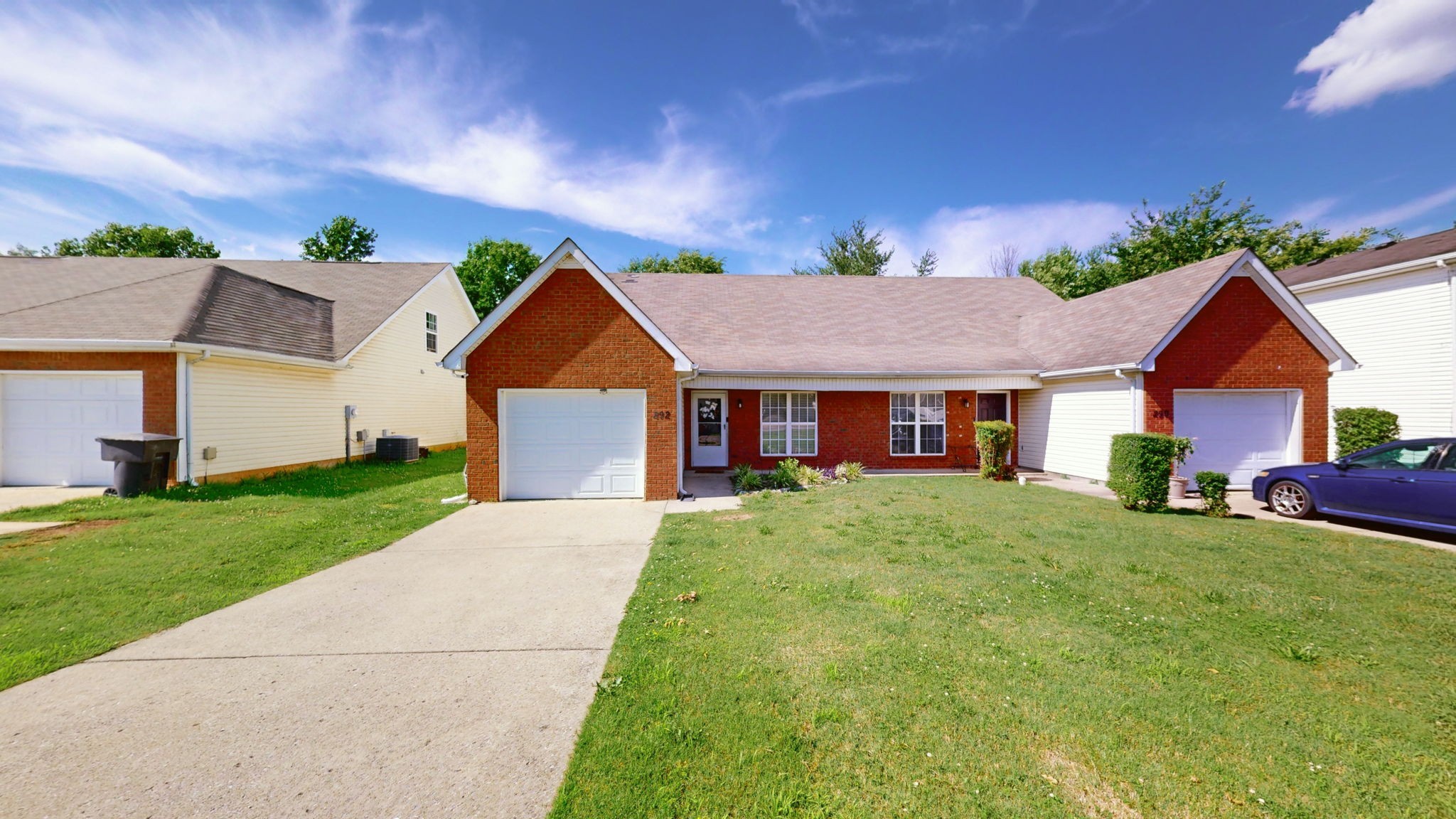 a aerial view of a house with a yard and garage