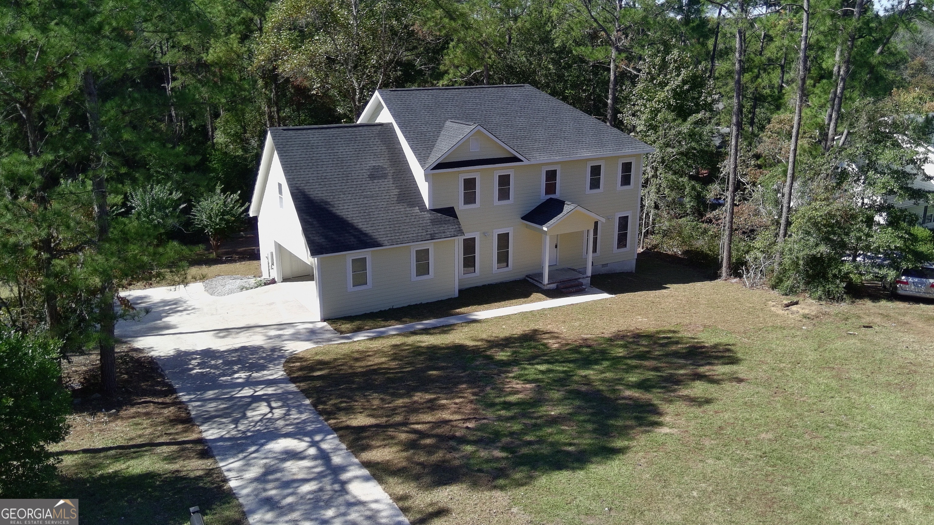 a aerial view of a house with a yard