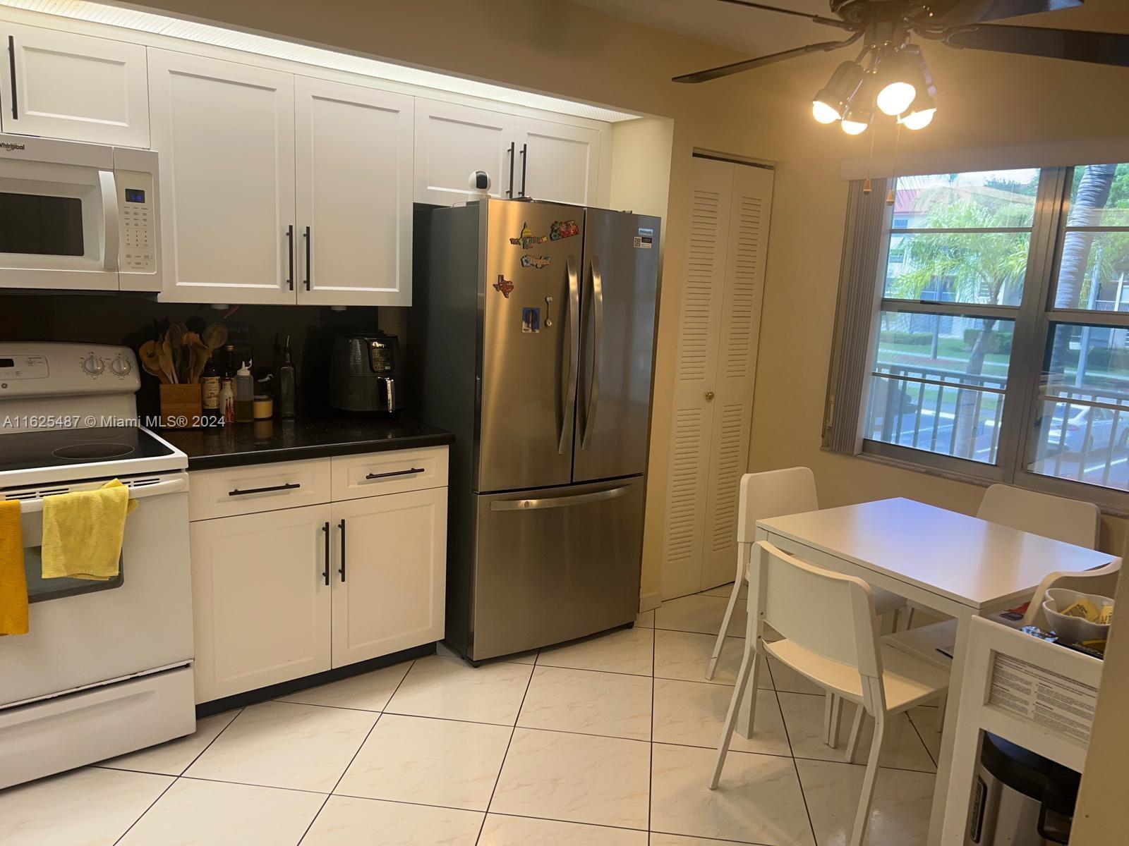 a kitchen with stainless steel appliances a refrigerator sink and cabinets