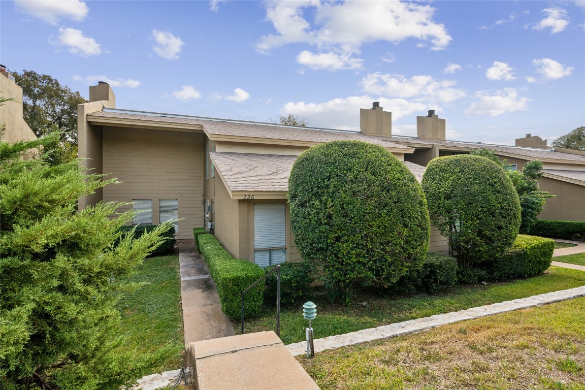 a front view of a house with garden