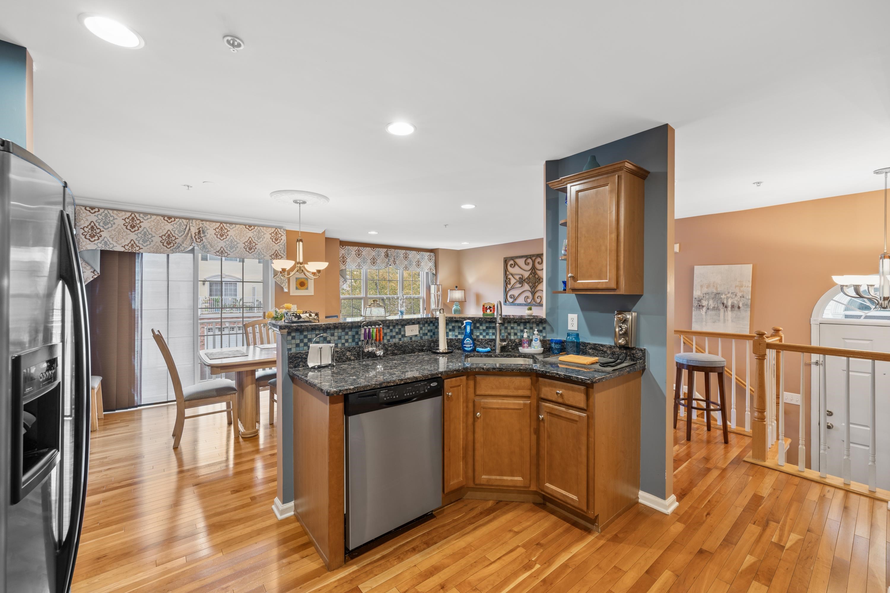 a kitchen with stainless steel appliances granite countertop a stove and a refrigerator