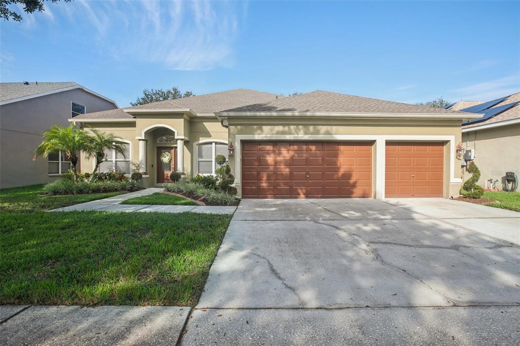 a front view of a house with a yard and garage