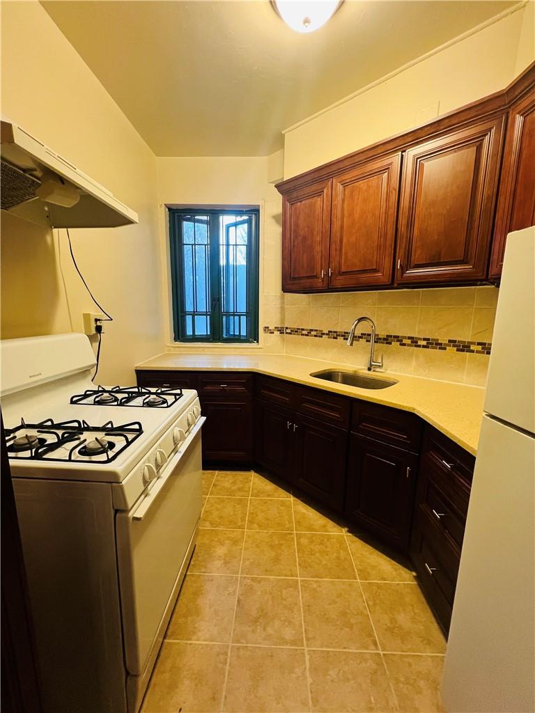 a kitchen with a sink and a stove