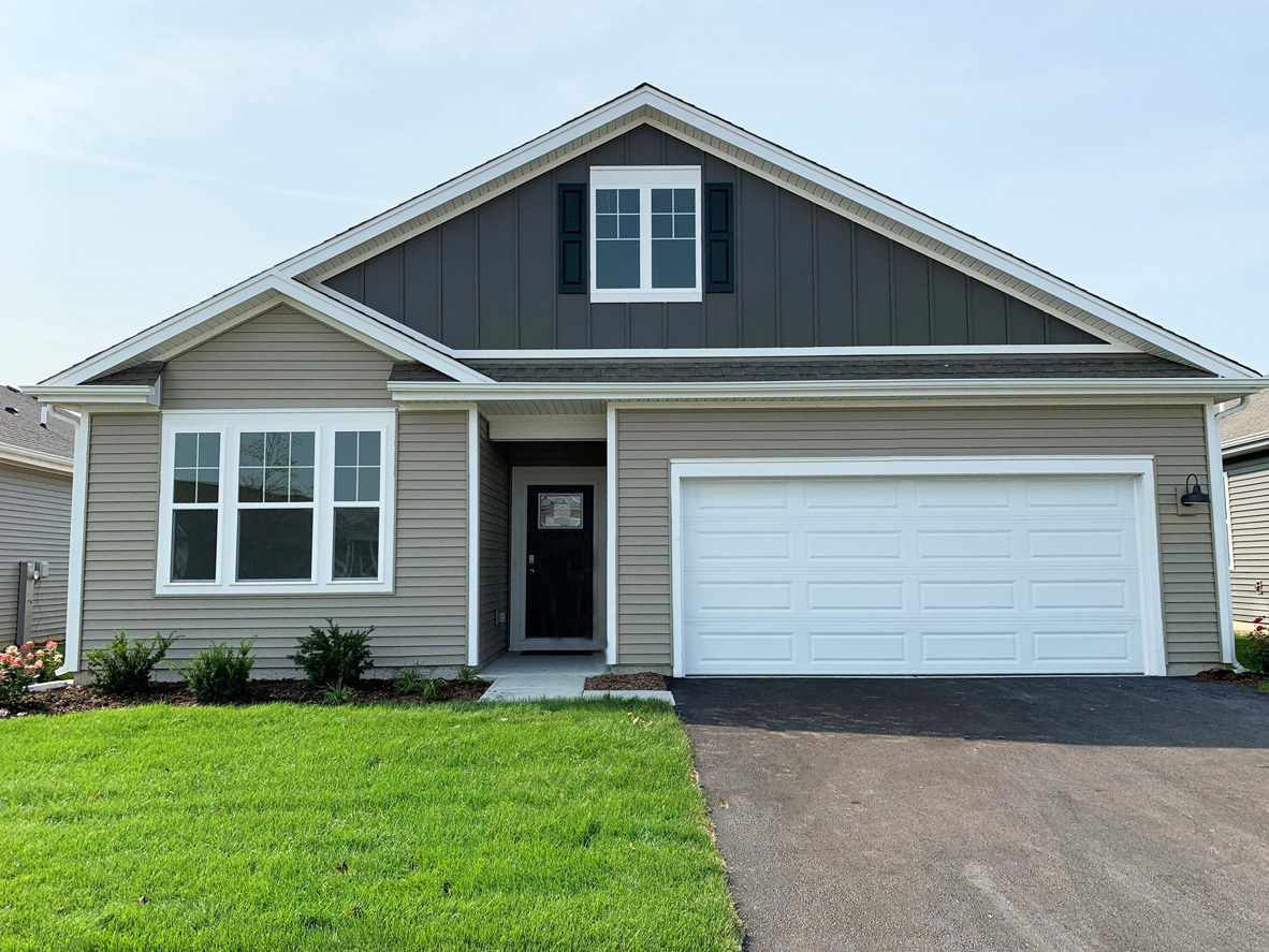 a front view of a house with a yard and garage