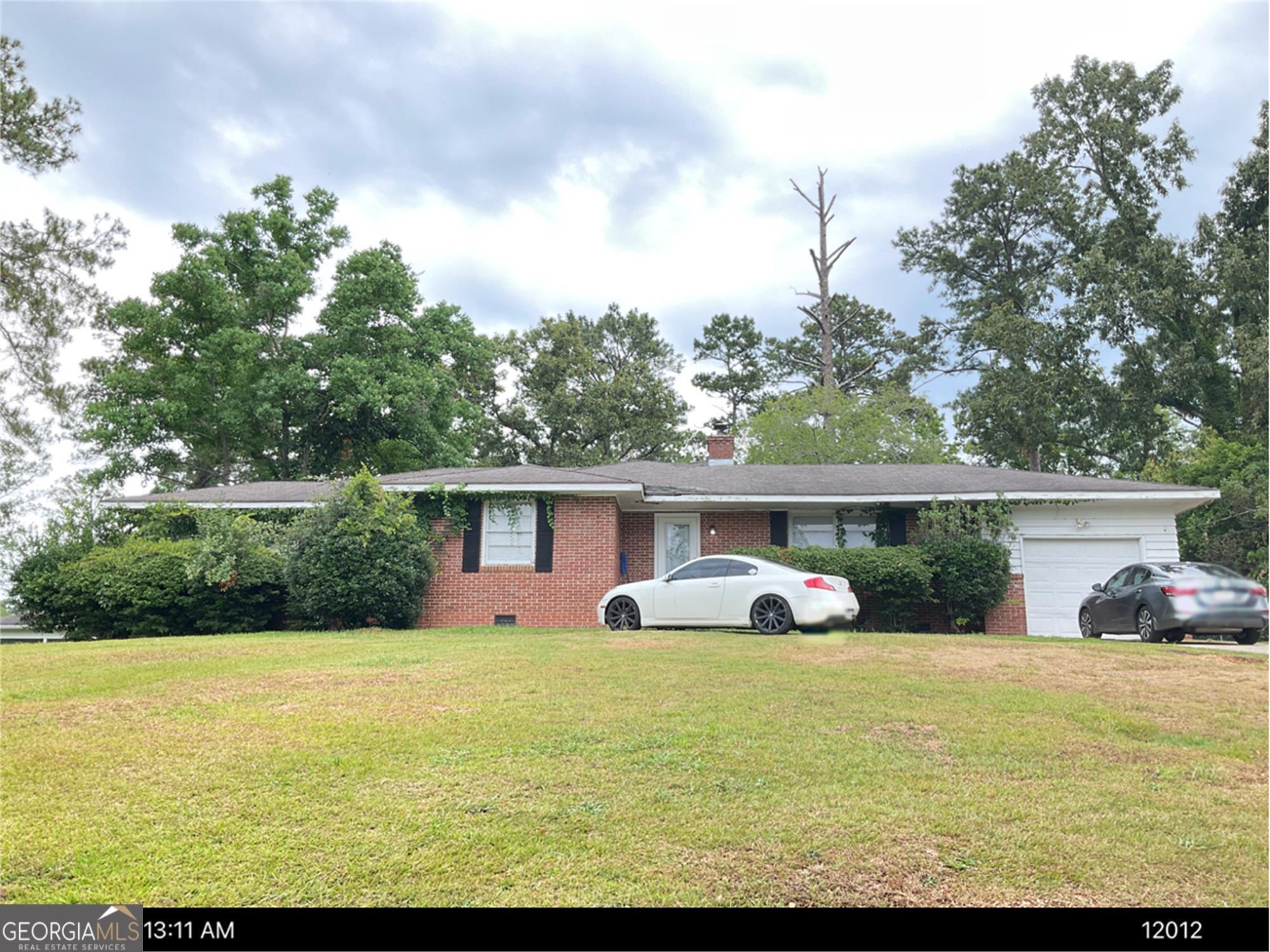 a front view of house with yard having outdoor seating