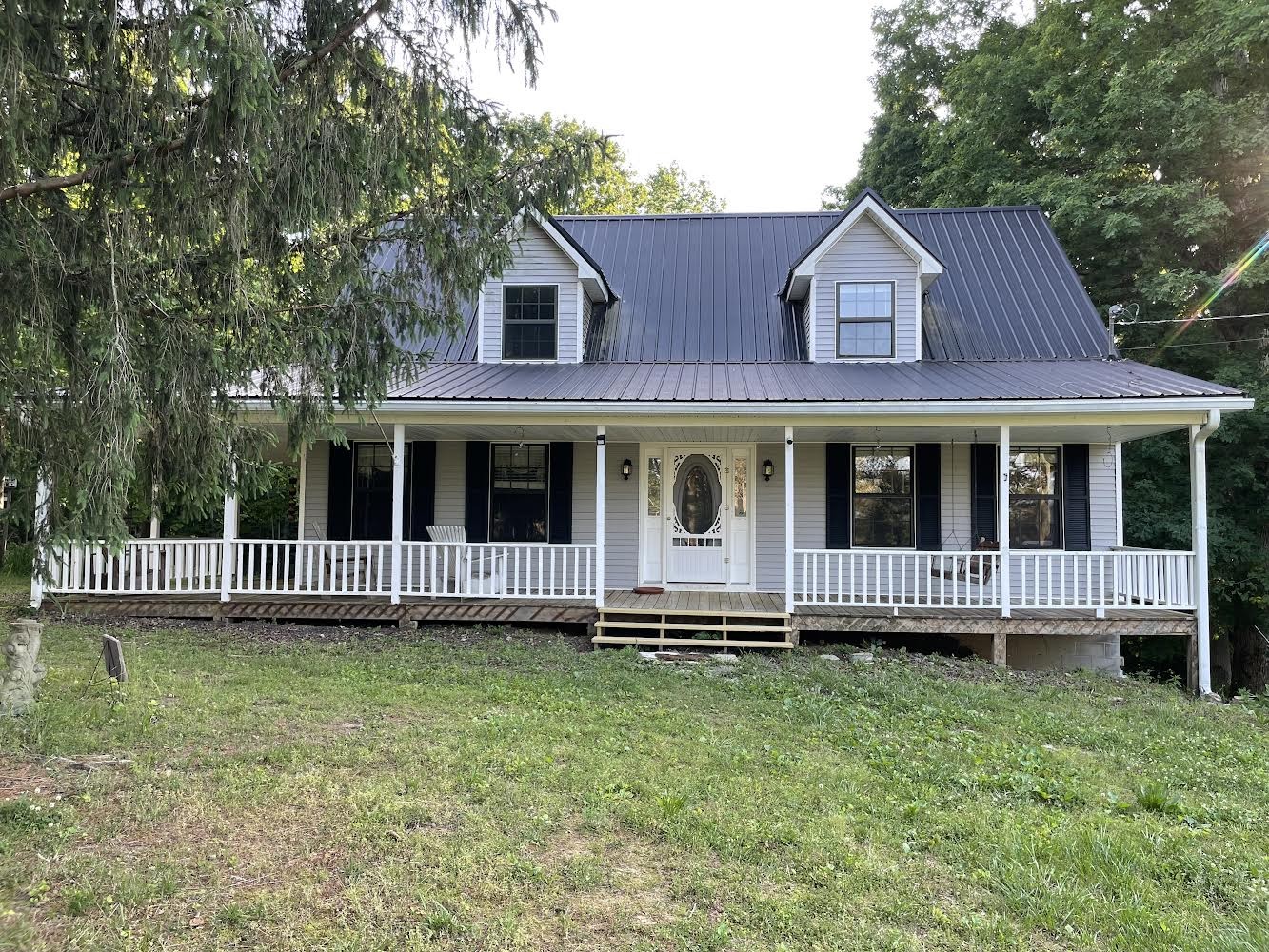 a view of a house with a yard and sitting area