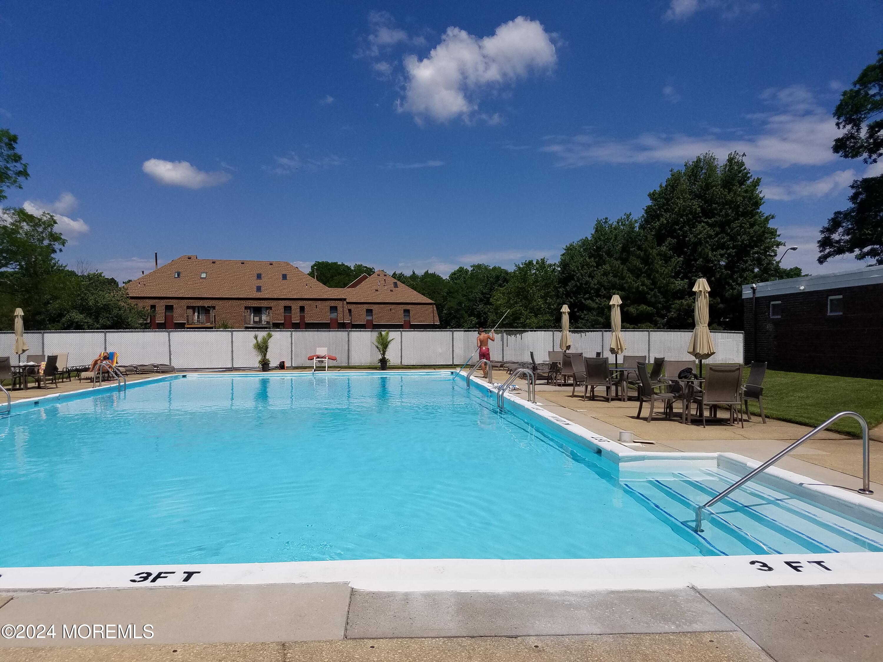 a view of a swimming pool with an outdoor seating