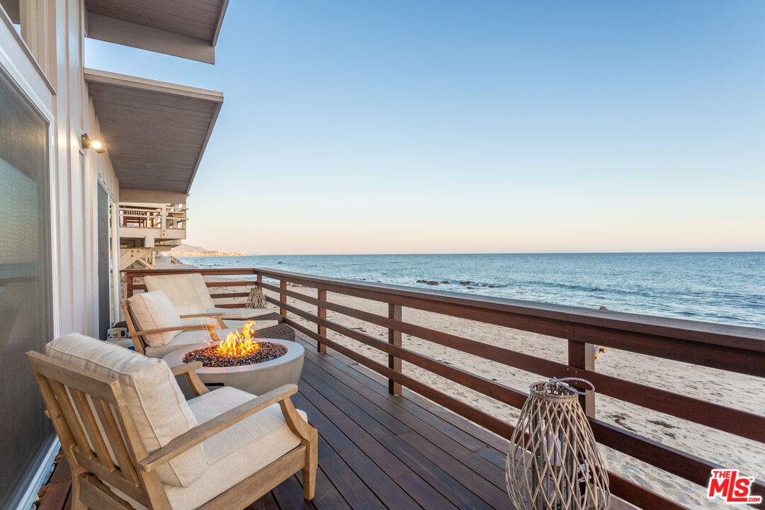 a terrace with outdoor seating and city view